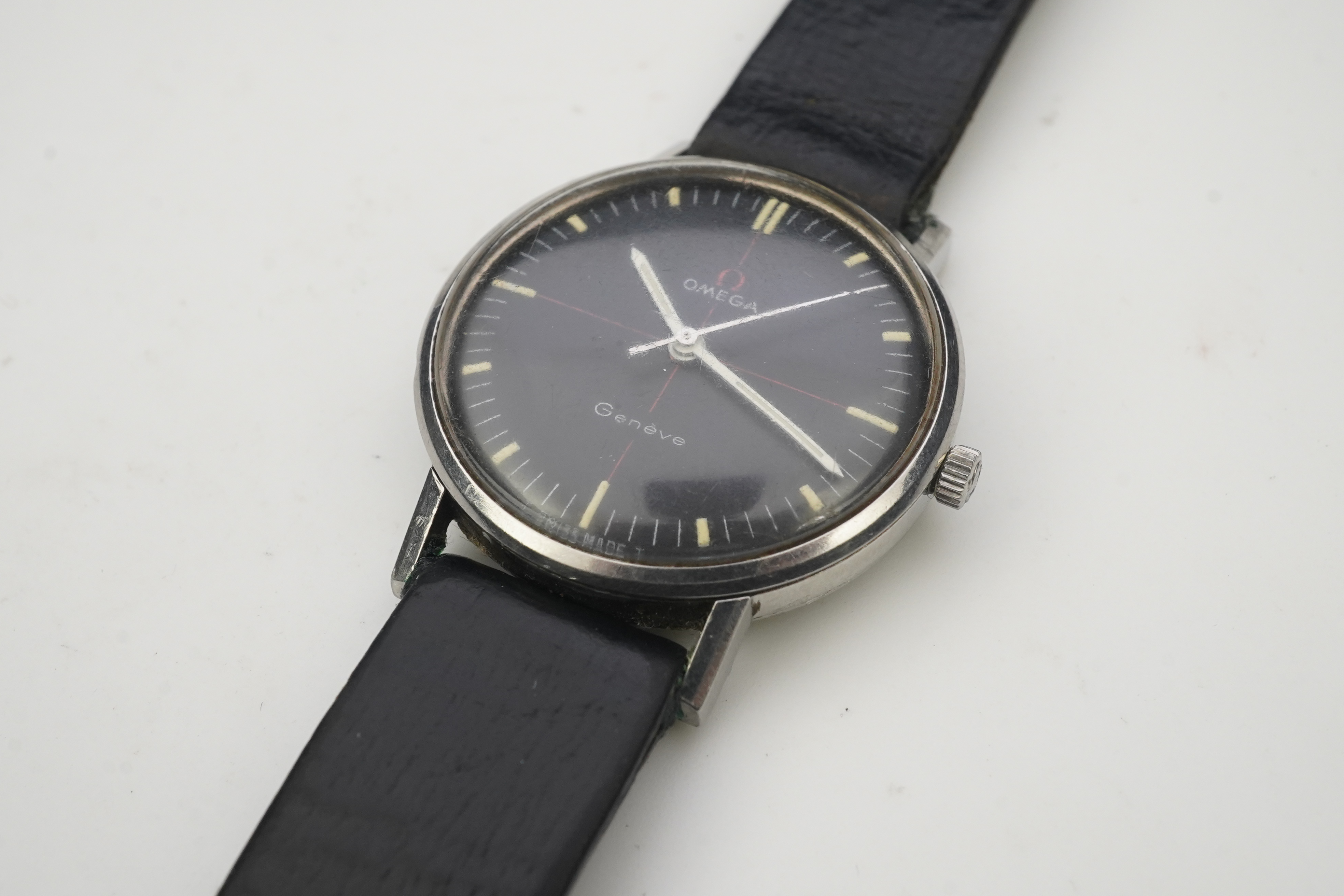 A gentleman's late 1960's/early 1970's stainless steel Omega manual wind wrist watch, the black dial with red cross-hair and baton numerals